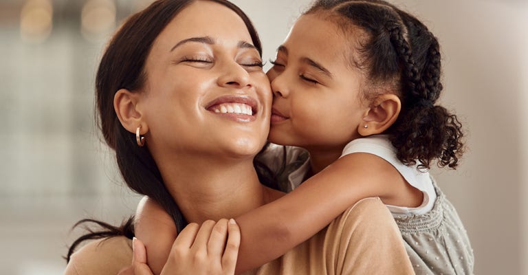 Happy, kiss and hug on mothers day in living room sofa, love and relaxing together in Australia family home. Young girl, smile parent and happiness, quality time and care on lounge couch for fun.